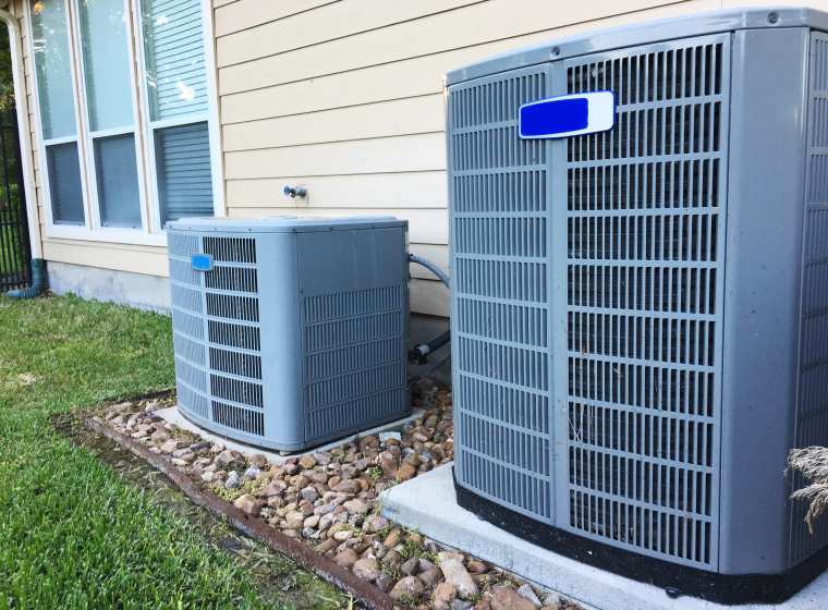 one big and one small central ac units beside each other acworth ga